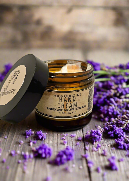 A jar of moisturizing hand cream with the lid off, labeled with natural ingredients like lavender and calendula.